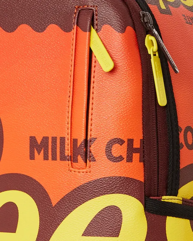 BACKPACKS>SPRAYGROUND REESE'S SHARK BITE BACKPACK (DLXV)